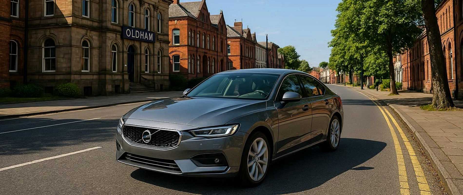 A row of parked cars beside modern flats in oldham