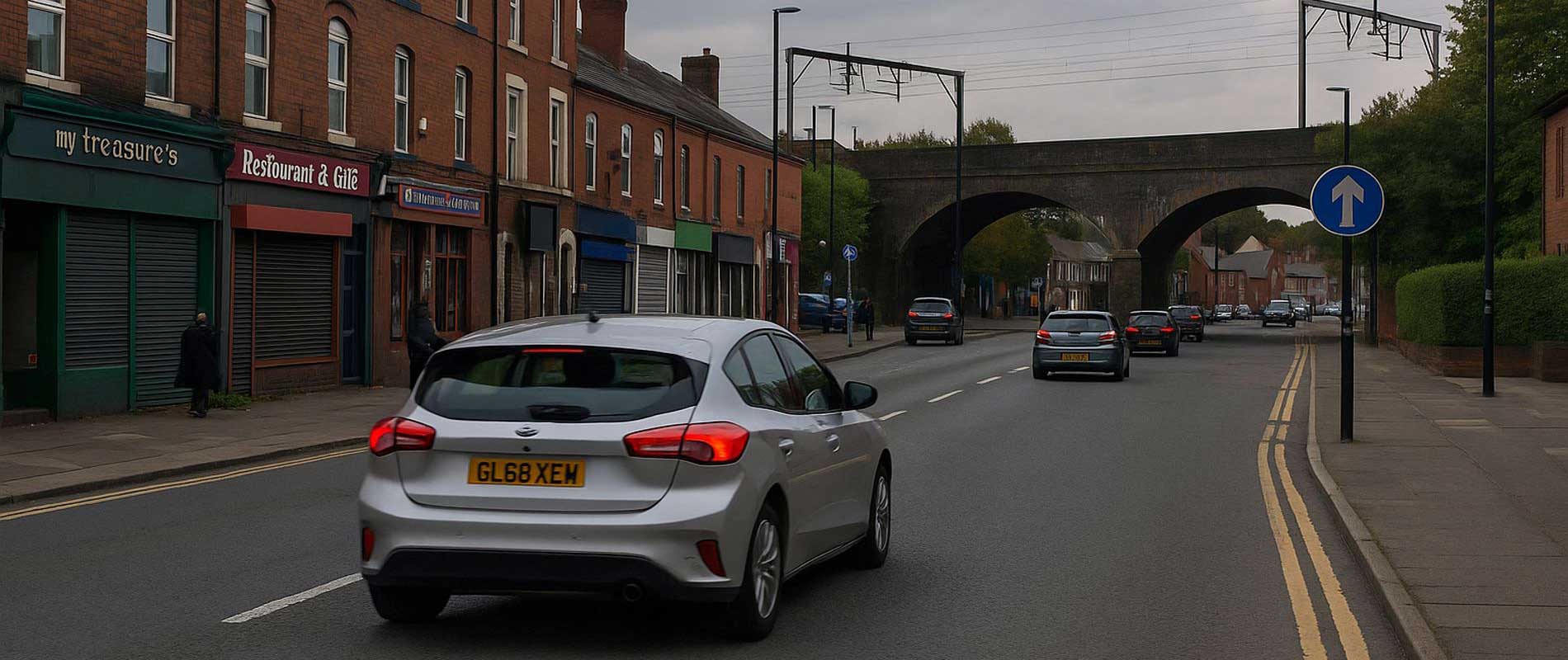 Cars waiting at a junction on a sunny day in salford